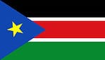 The flag of South Sudan consists of green, red, and black horizontal stripes. It also holds thin white stripes and a blue triangle on the left side of the flag, with a yellow star in the middle of the triangle.