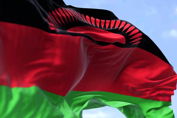 Detail of the national flag of Malawi waving in the wind on a clear day. Malawi is a landlocked country in Southeastern Africa. Selective focus.
