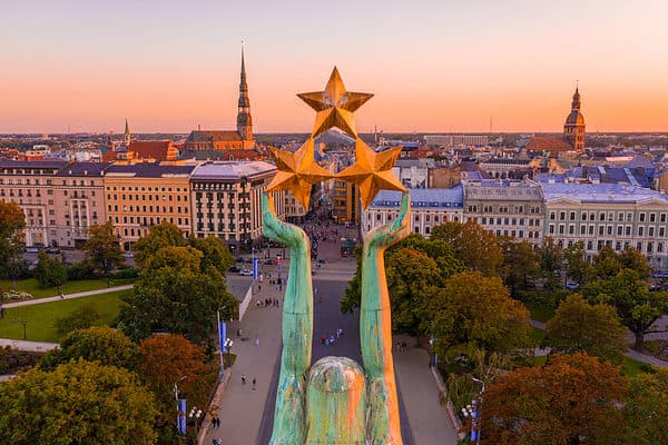 An amazing Aerial View of the Statue of Liberty Milda in Riga, Latvia during sunset