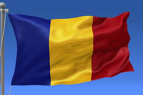Chad flag waving on the flagpole on a sky background
