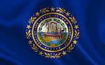 The flag of New Hampshire consists of a dark blue field with the state seal in the center.