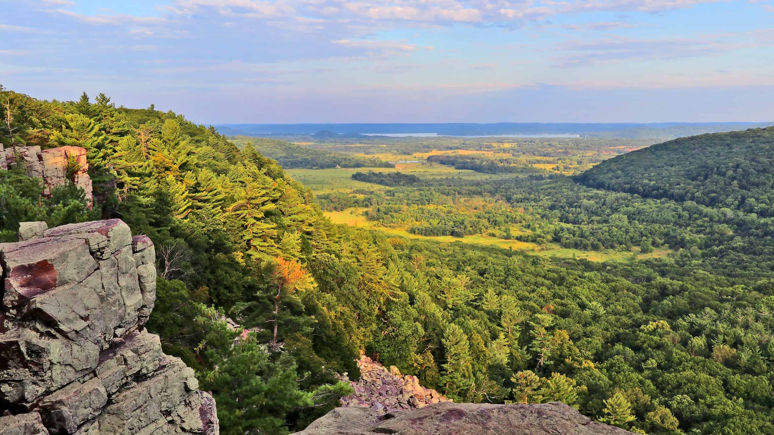 Beautiful Wisconsin summer nature background. Areal view from rocky ice age hiking trail during sunset hours. Devil's Lake State Park, Baraboo area, Wisconsin, Midwest USA.