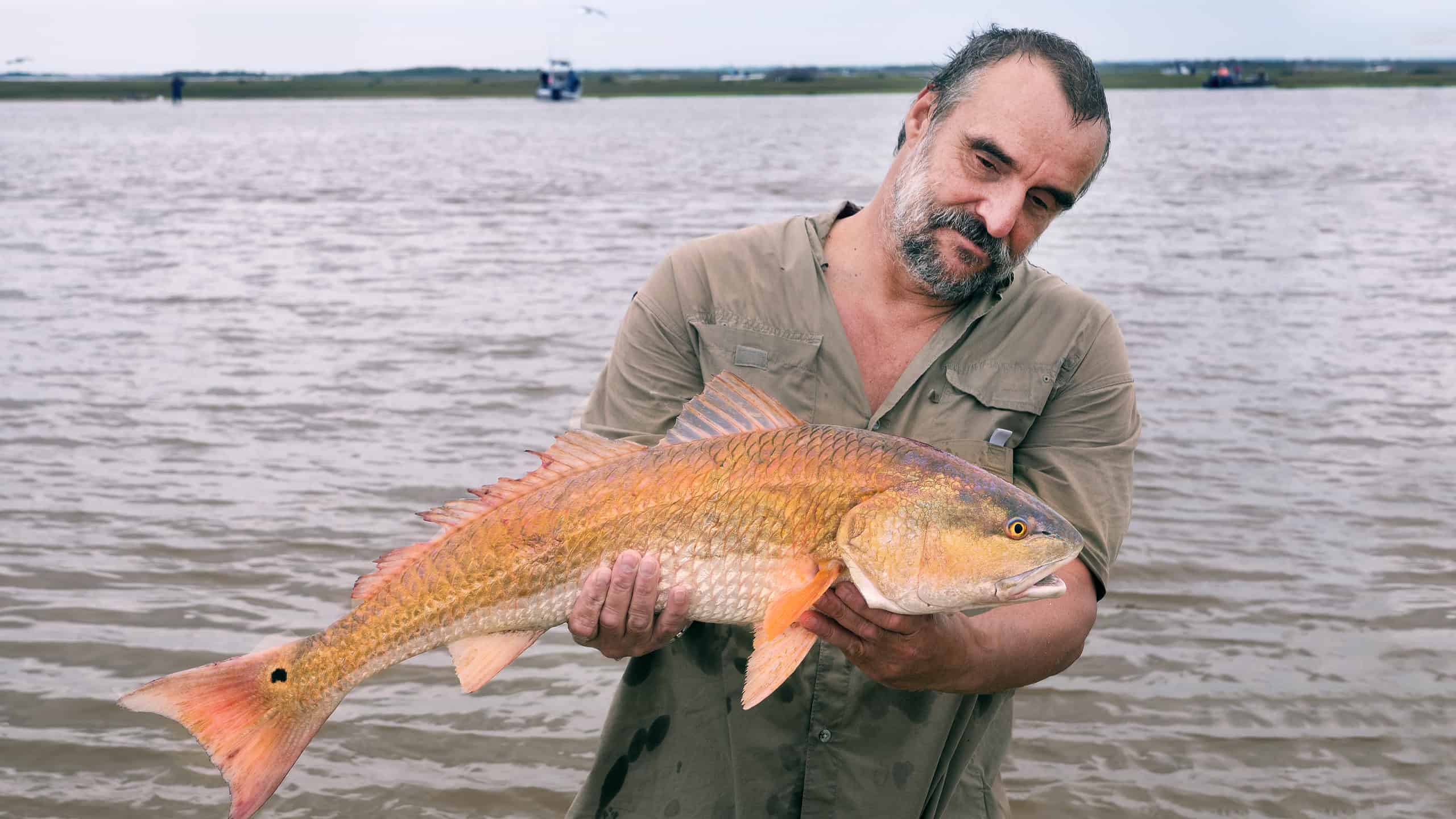 Man holding a large red drum