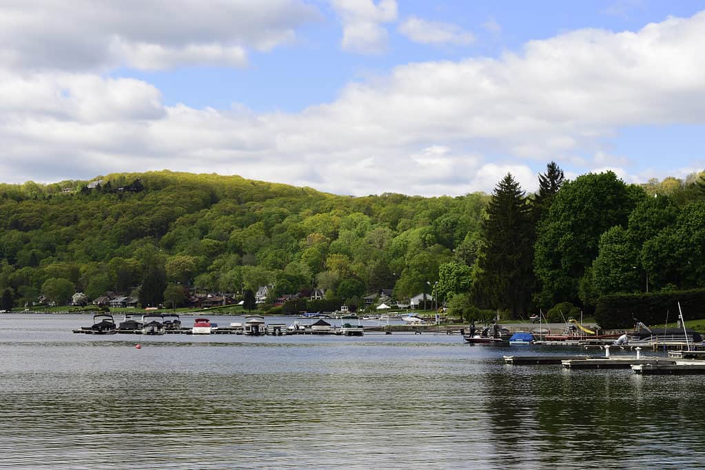 Candlewood Lake on a calm summer morning with docked boats and mountains in the background, New Fairfield, Connecticut.