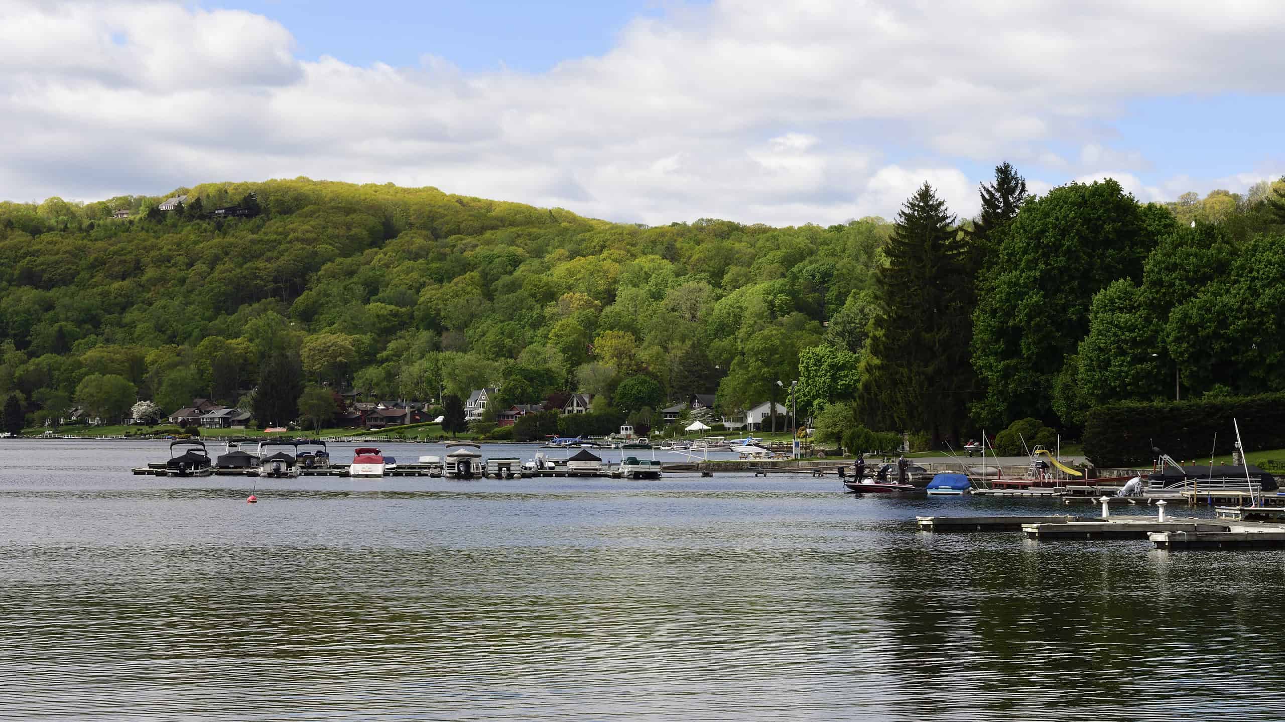 Candlewood Lake on a peaceful summer morning with boats docked and mountainside in background,New Fairfield,Connecticut.