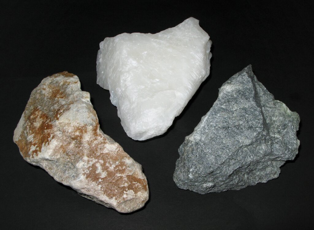 Samples of soapstone in white, gray, and multi-colored (reddish) shades