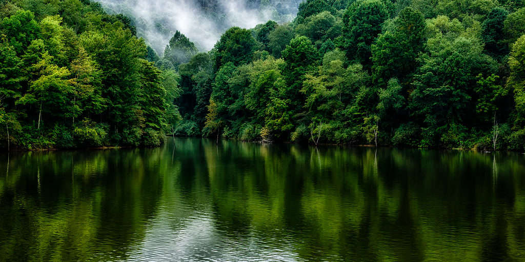 Stonewall Jackson Lake reflecting the vibrant colors of the surrounding forest. 