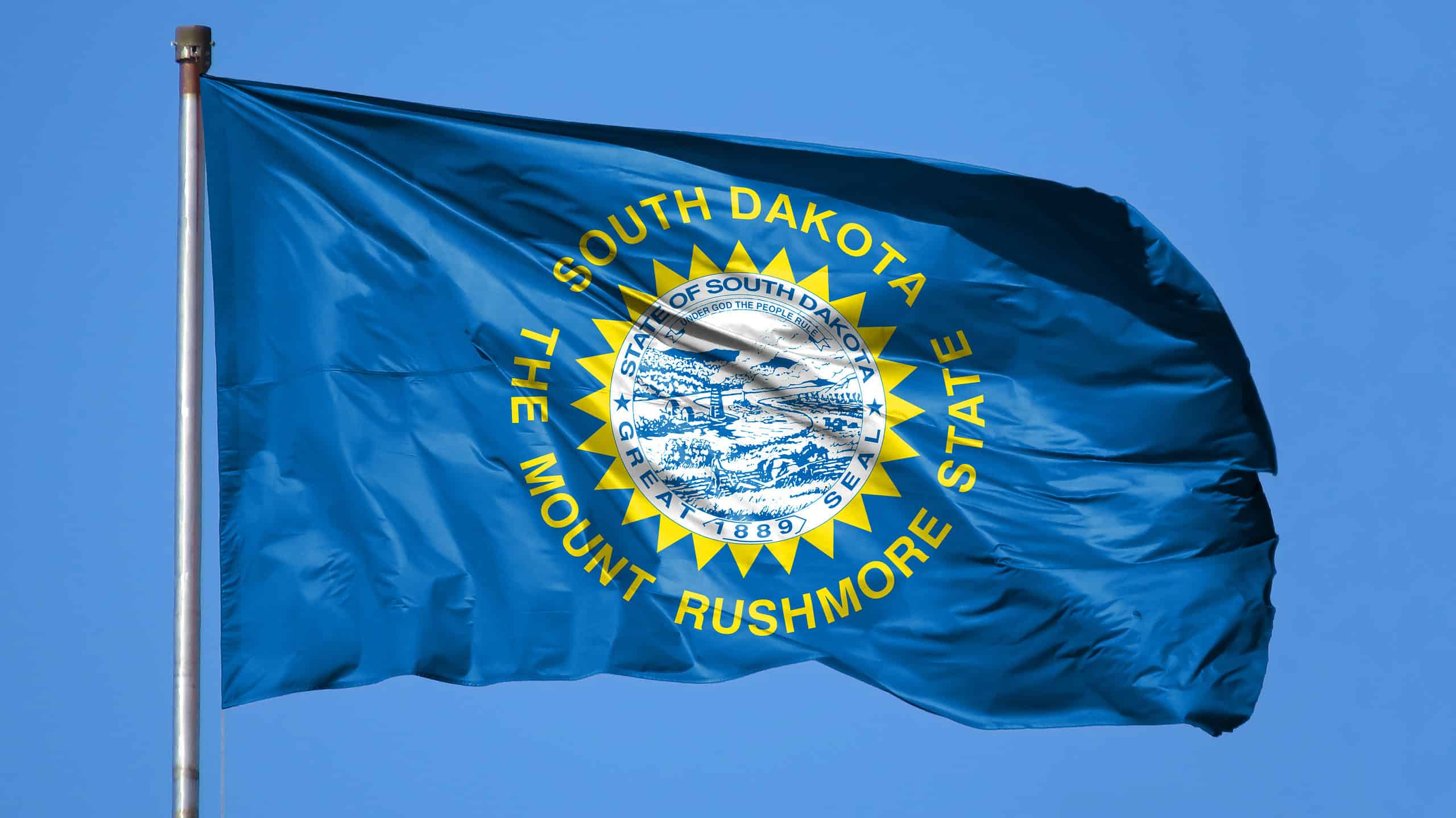 Flag of South Dakota against blue sky