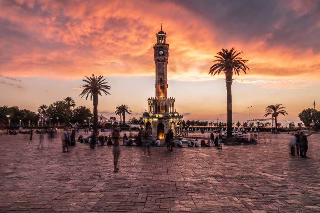 Konak Square street view with old clock tower. It was built in 1901 and accepted as the official symbol of Izmir City, Turkey