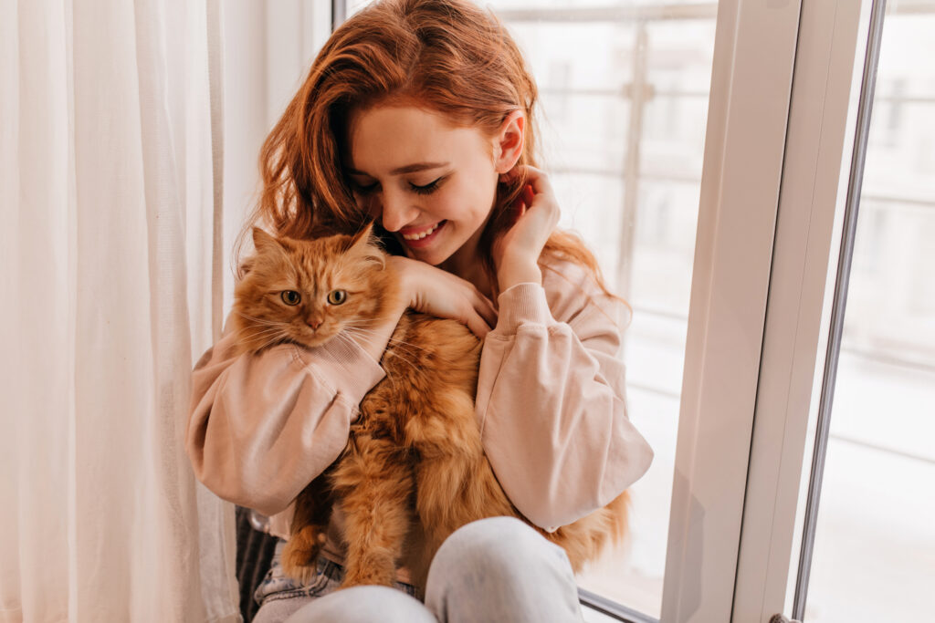 Orange tabby cat and redhead mom