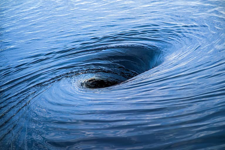 The raging whirlpool. Huge whirlpool on a water surface