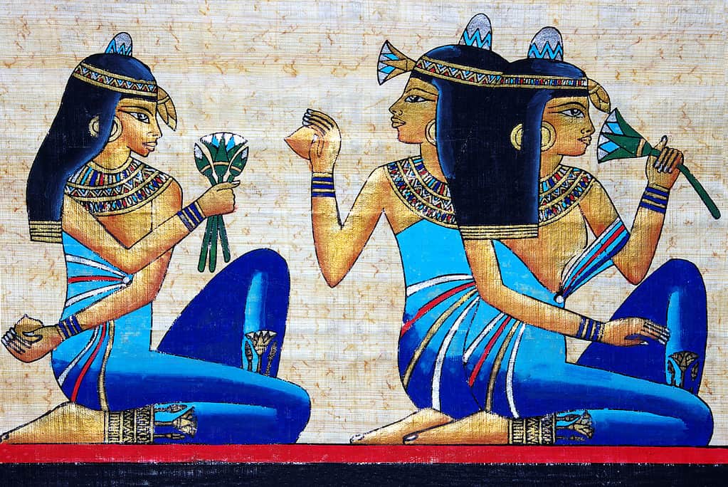Artwork with three Egyptian women holding lotus flowers