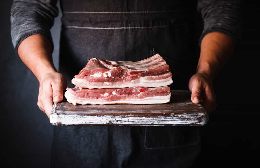 chef holding raw pork