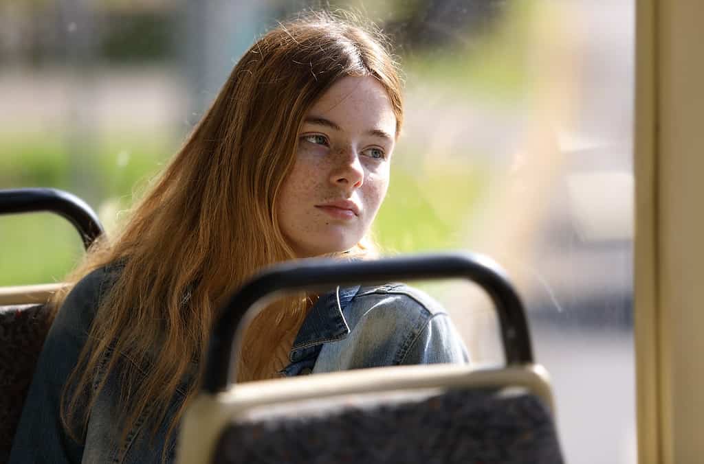 Girl sits on bus