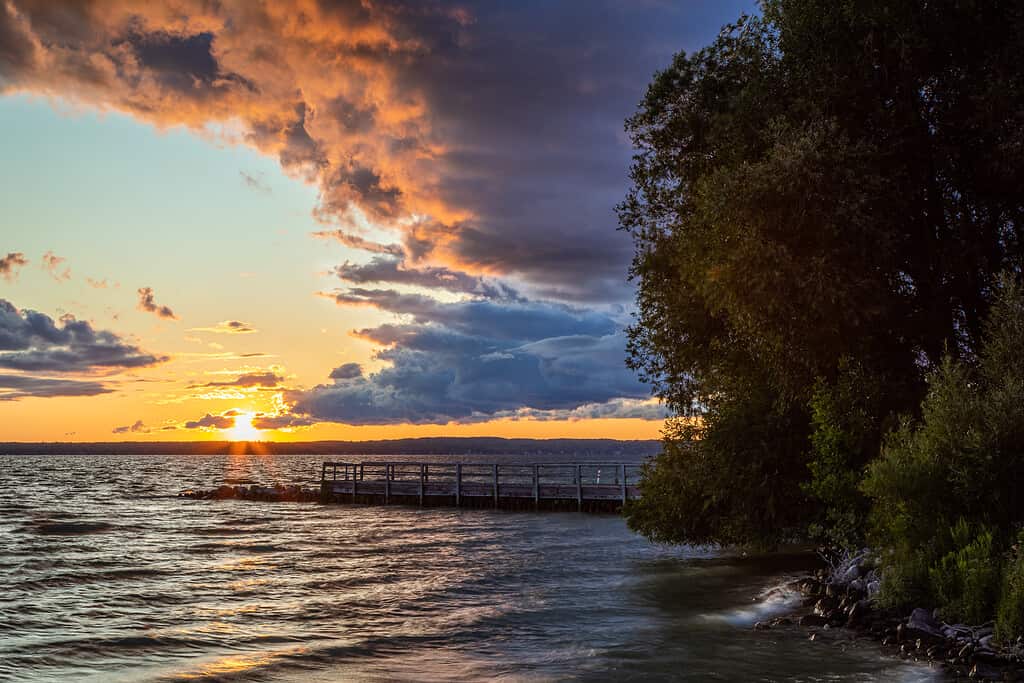Cheboygan Michigan Aloha State Park on Mullet Lake at sunset with storm clouds sunset and waves