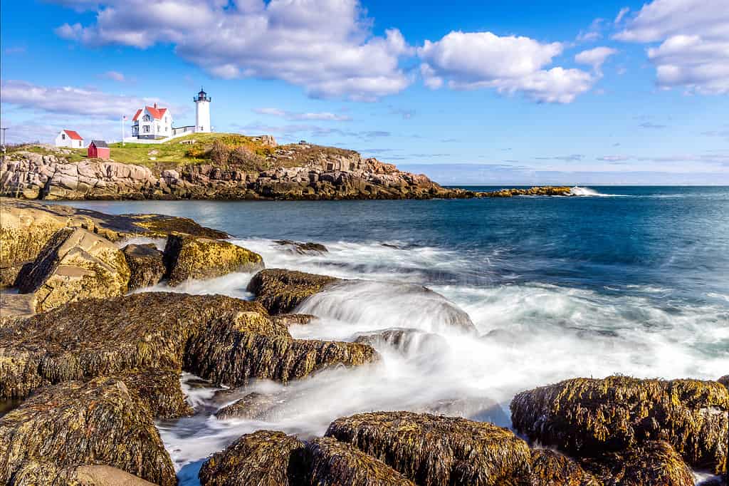 View of one of the best beaches in Maine with Cape Neddick lighthouse in the background