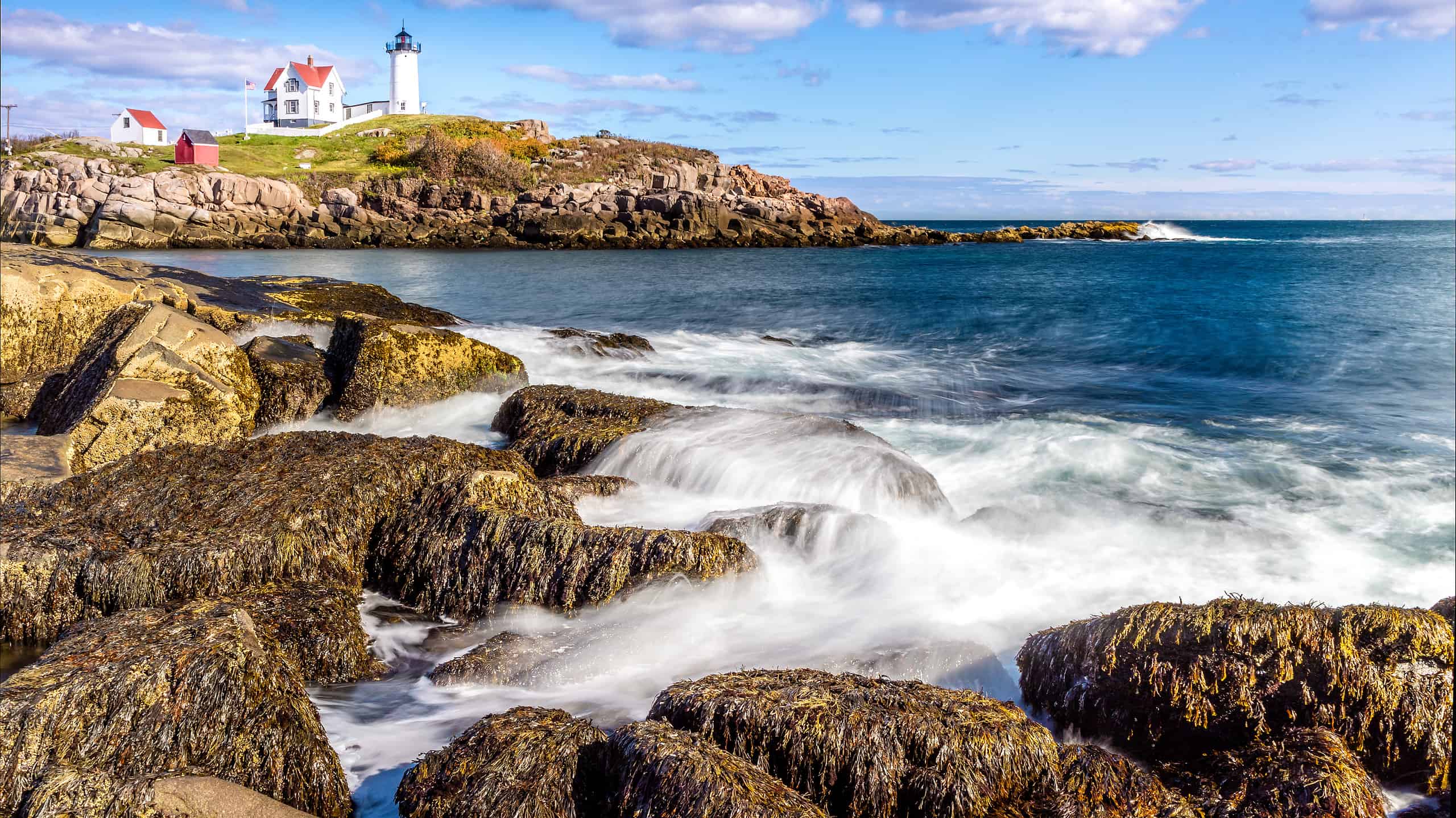View of one of the best beaches in Maine with Cape Neddick lighthouse in the background