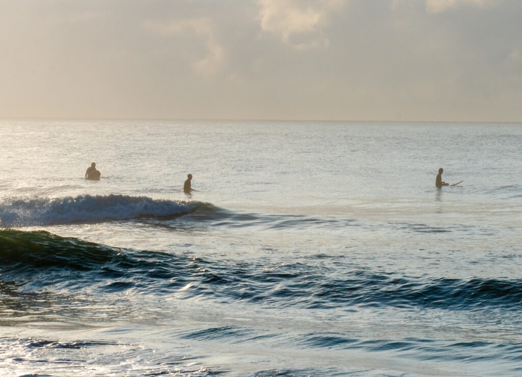 Surfers in the water during morning on Hatteras Island