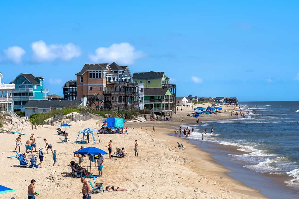 Rodanthe North Carolina - July 17 2022: View of people and vacation homes on the beach as seen from the Rodanthe Pier in the Outer Banks