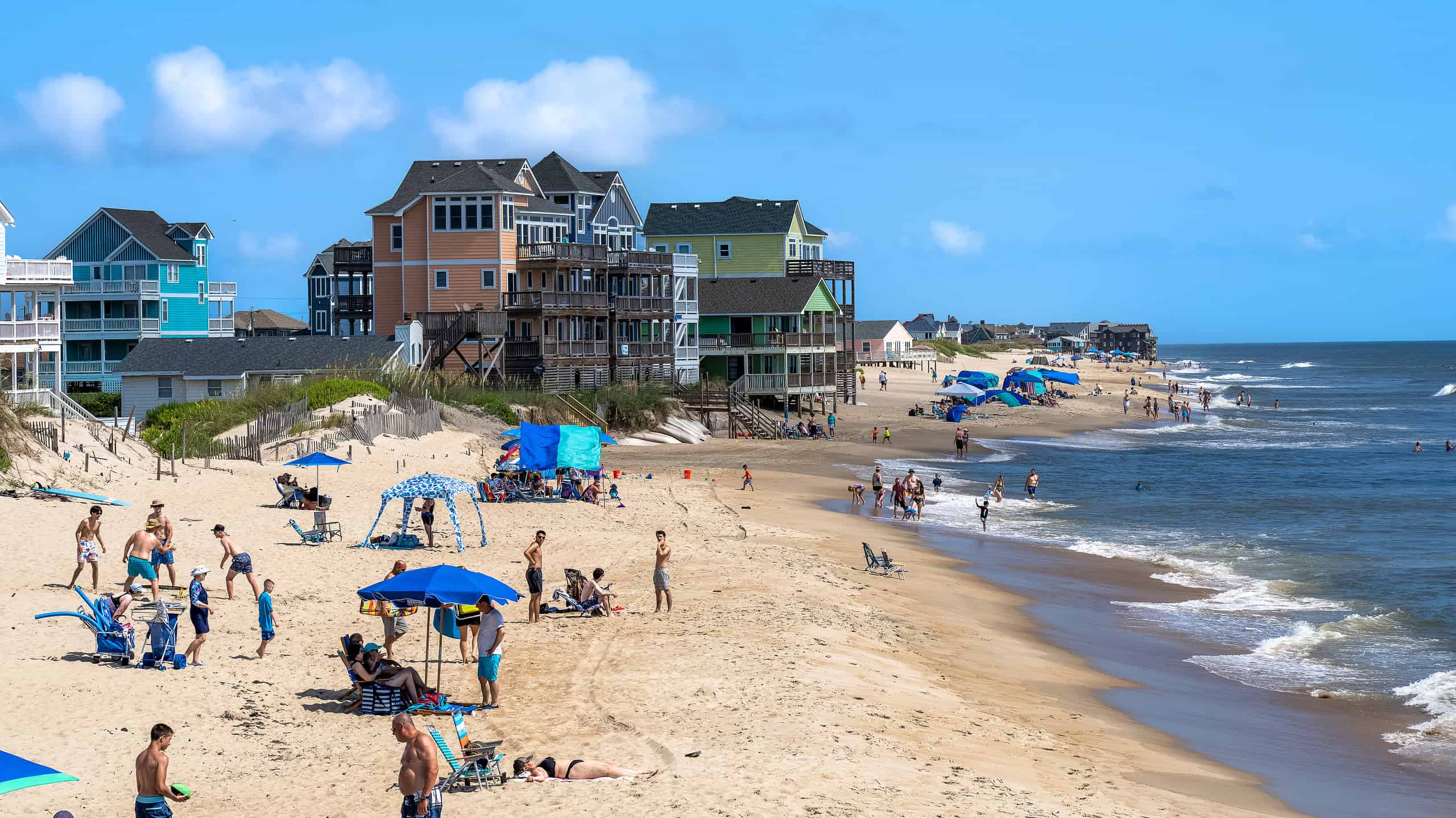 Rodanthe North Carolina - July 17 2022: View of people and vacation homes on the beach as seen from the Rodanthe Pier in the Outer Banks
