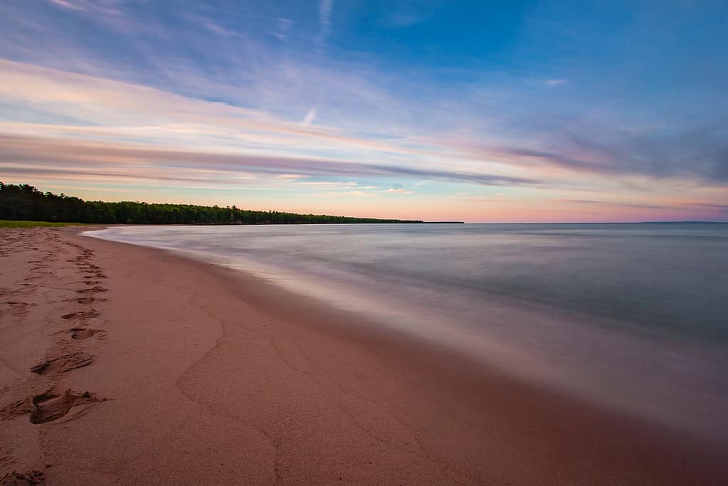 A long exposure captures the smoothness of the waves at the beach on Madeline Island in the Apostle Islands in Lake Superior