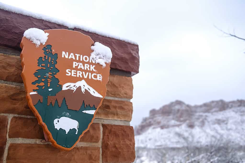 National Park Service sign on wall with snow