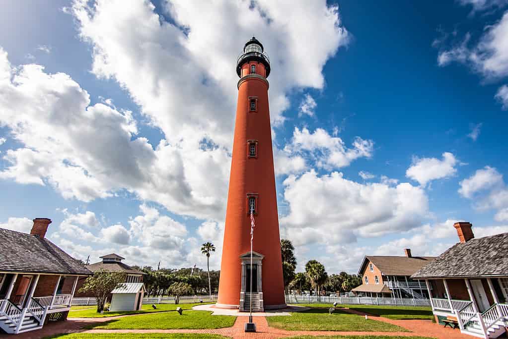 Ponce Inlet lighthouse in Ponce, Florida, set against the sunny cloudy sky