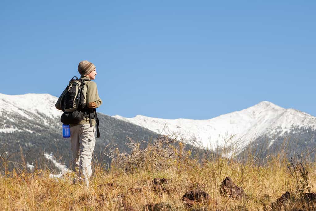 Hiker Stops to Look at Mountain View (Humphrey's Peak in Flagstaff, Arizona)