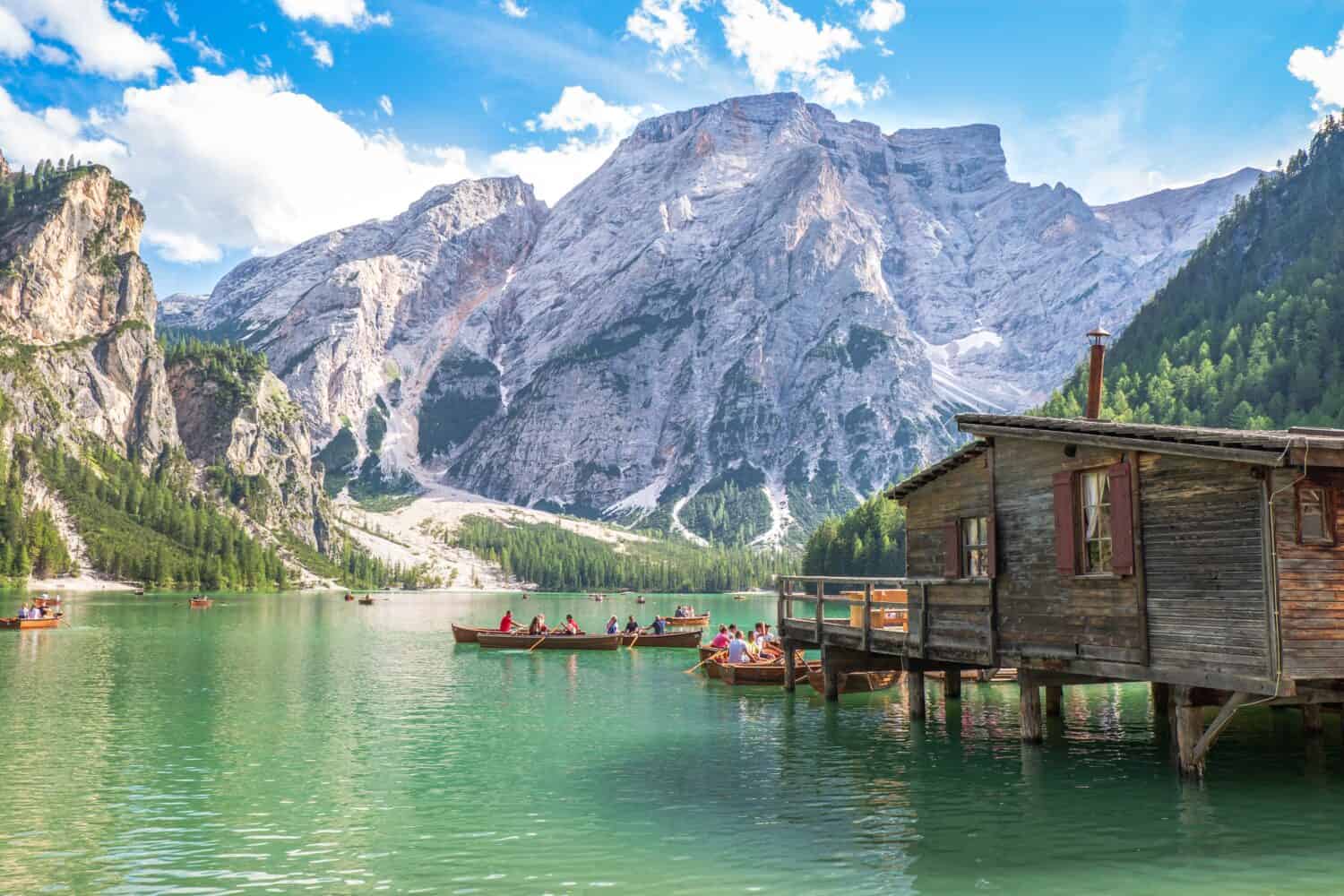 Lake Braies (also known as Pragser Wildsee or Lago di Braies) in Dolomites Mountains, Sudtirol, Italy. Romantic place with typical wooden boats on the alpine lake. Hiking travel and adventure.