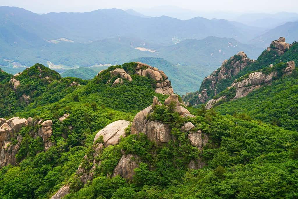 High angle and summer view of rocks and cliff of Munjangdae Peak at Songnisan National Park near Sangju-si, South Korea