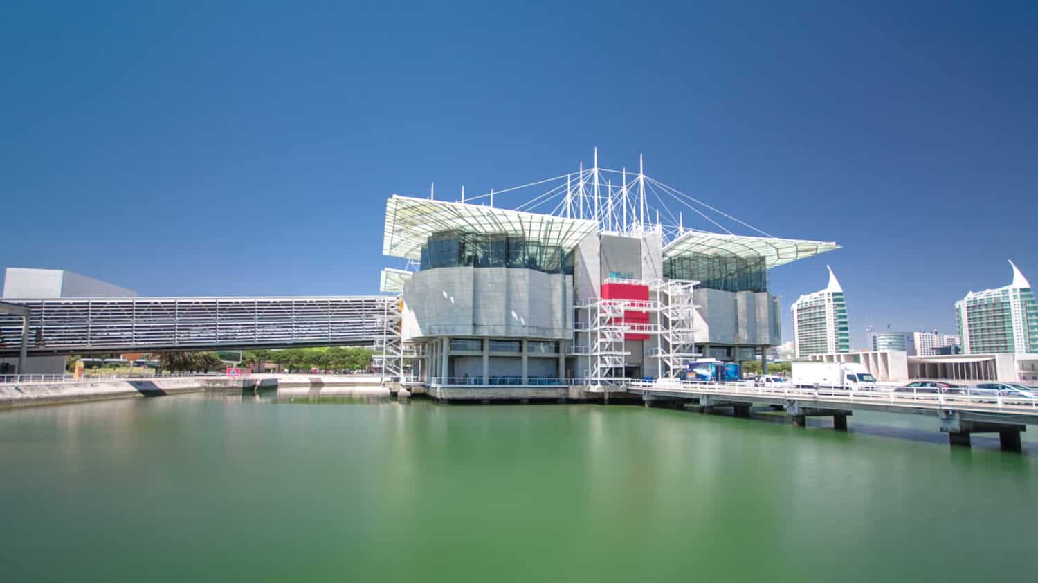 Lisbon Oceanarium, the second largest oceanarium in the world and the biggest in Europe. Parque das Nacoes. Portugal. Timelapse hyperlapse with blue sky and green water 4K