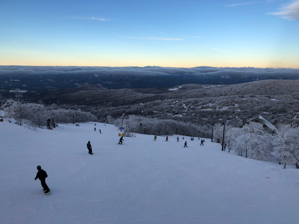 The top of Beech Mountain, North Carolina. Beautiful white powder snow with gorgeous forests and mountains with sunsetting.