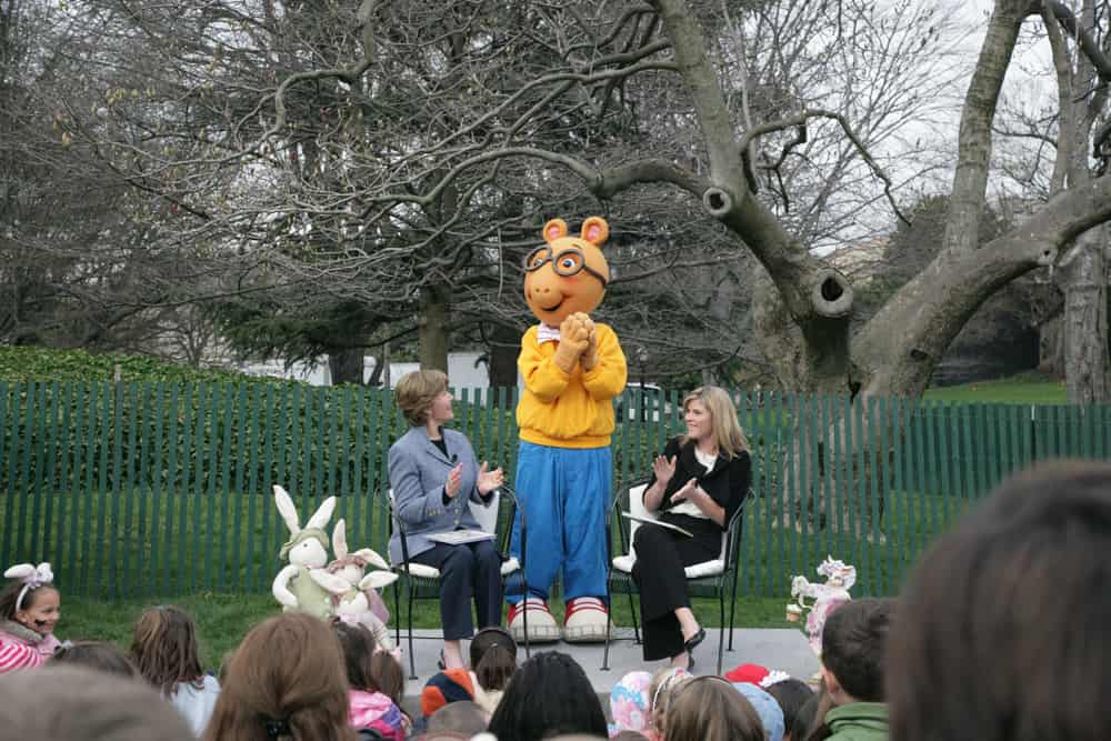 Mrs. Laura Bush, joined by her daughter, Jenna, applauds the PBS character "Arthur," following the reading of "Arthur Meets the President," Monday, March 24, 2008, during festivities at the 2008 White House Easter Egg Roll on the South Lawn of the White House.