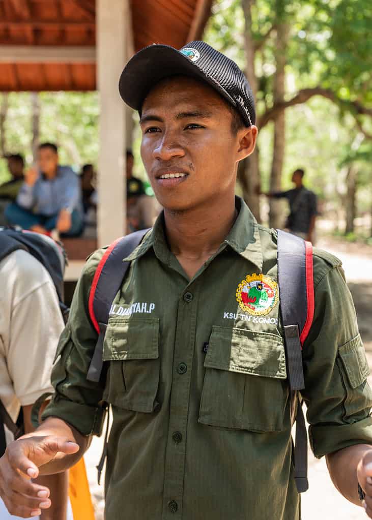 Komodo Island, Indonesia - February 24, 2019: Komodo National Park. Portrait of Young man in dark green garb is a ranger, guide in the park.