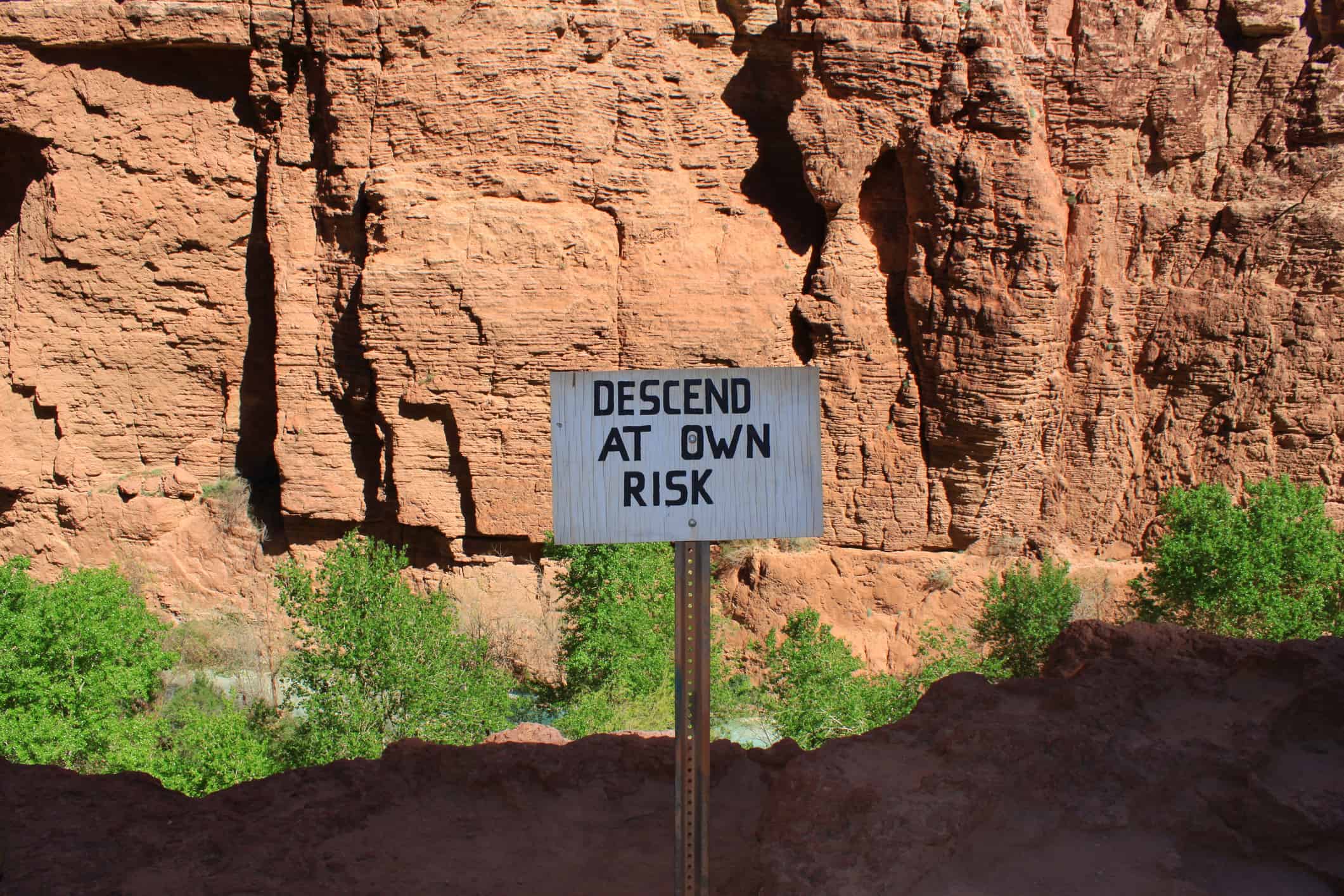 Sign with "descend at your own risk" at Havasupai Indian Reservation in Arizona