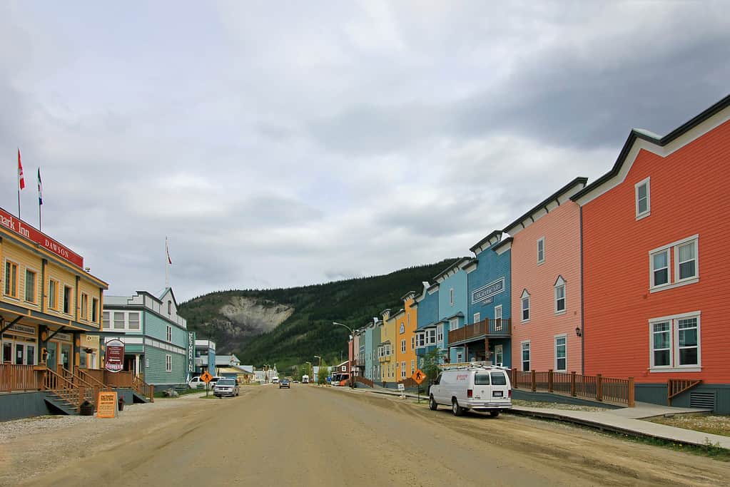 Historic buildings and typical traditional wooden houses in a main street in Dawson City, Yukon, Canada.