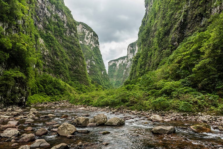 Hiking through the Atlantic Rainforest inside Itaimbezinho Canyon in Boi River, Aparados da Serra National Park, Cambara do Sul, Rio Grande do Sul State, South Brazil