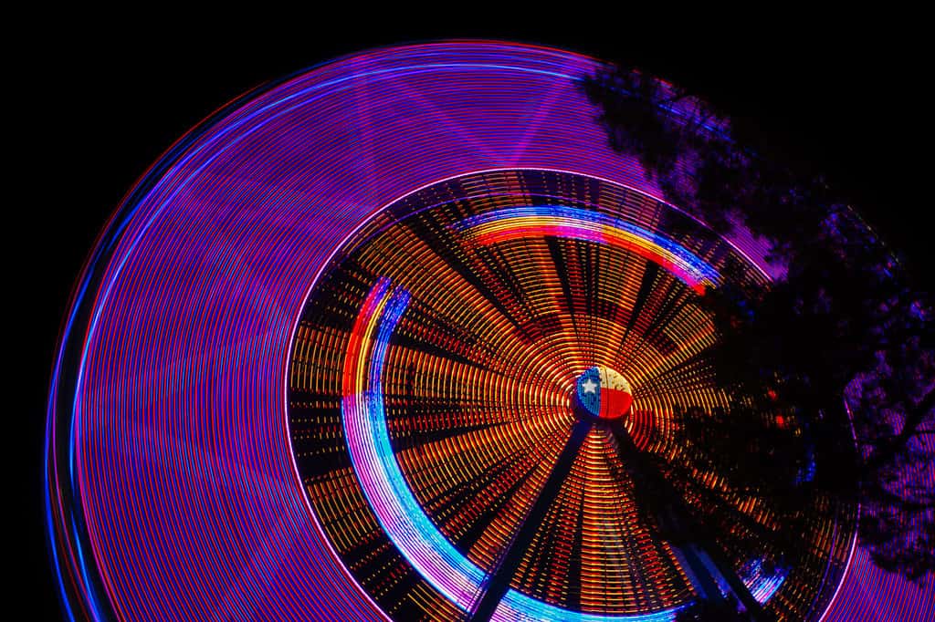Texas star ferris wheel at night at state fair of Texas.