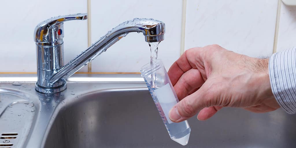 Drinking water in the test tube for chemical and microbiological analysis