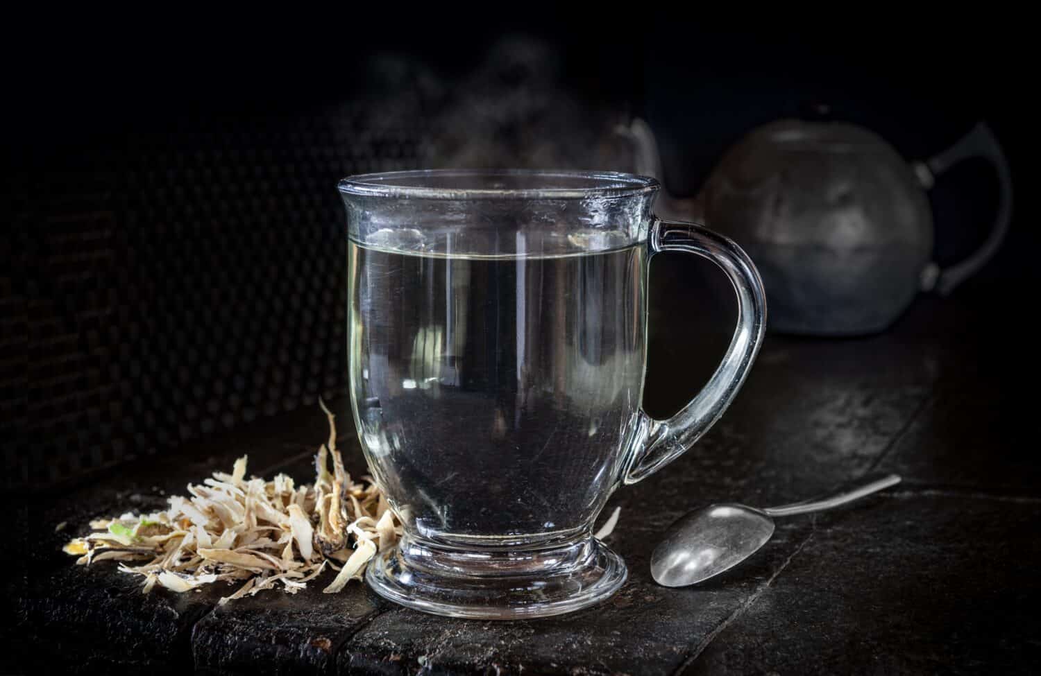 Ocotillo bark tea in a glass cup with ocotillo bark on side, Fouquieria Splendens