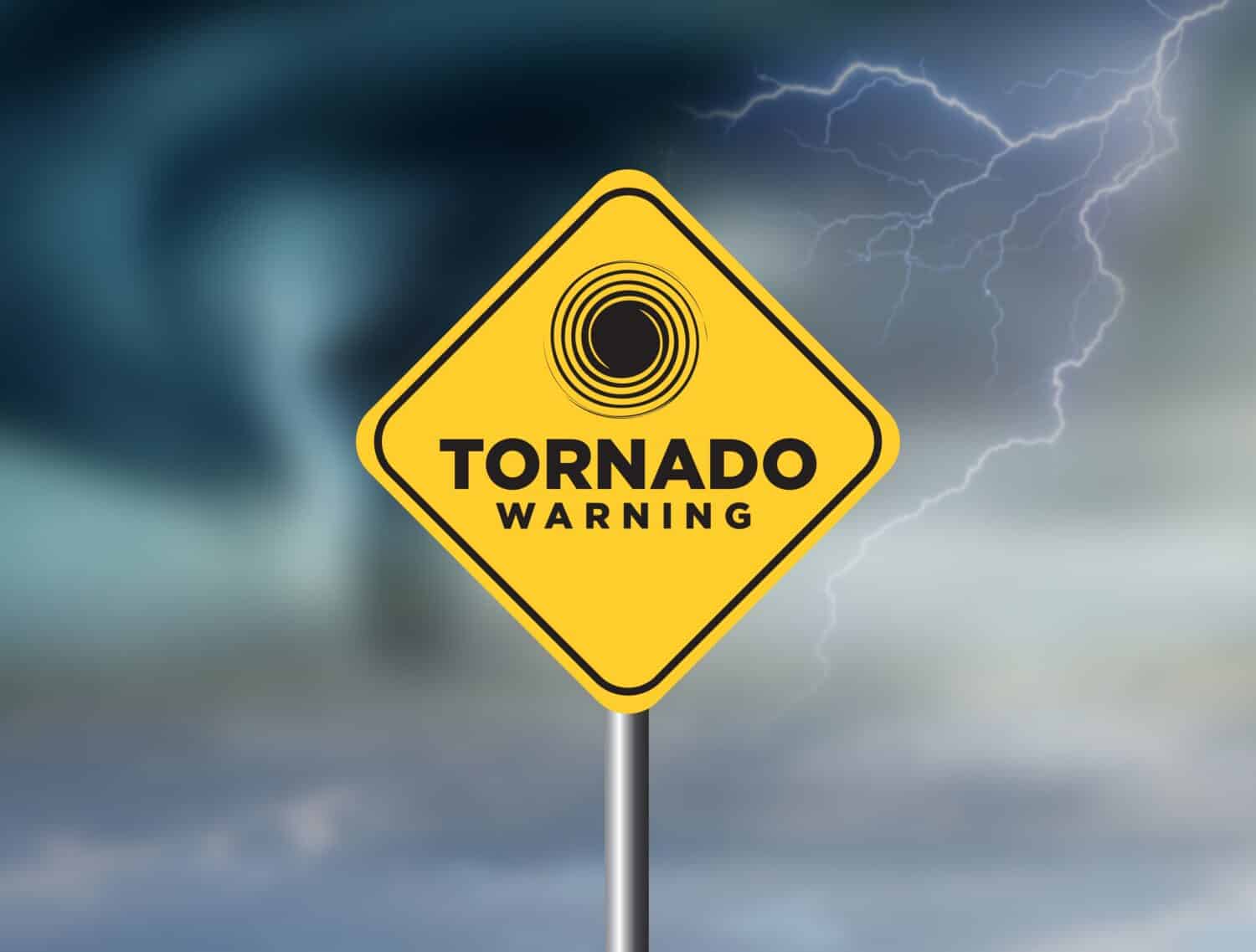 Tornado warning sign against a powerful stormy background with copy space. Dirty and angled sign with cyclonic winds add to the drama.