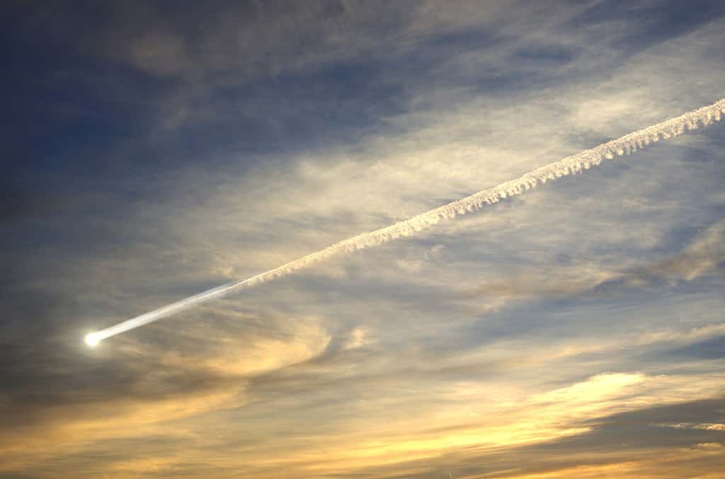 flying smoky meteor on background of sky