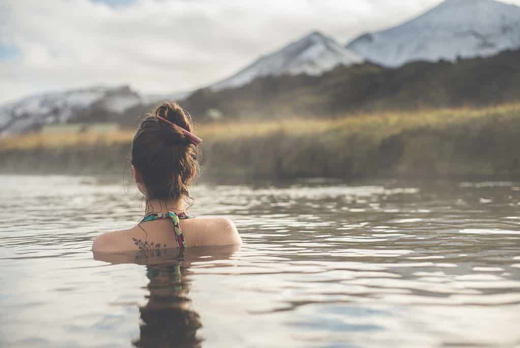 woman soaking in a hot spring in Iceland