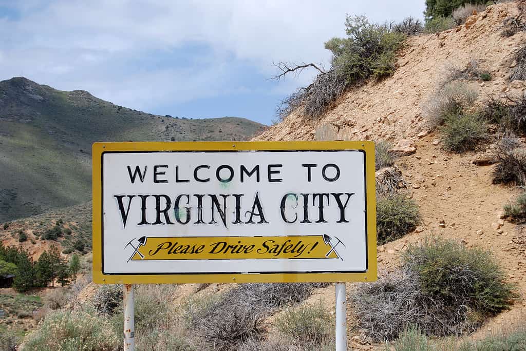 Virginia City Sign. White sign with goldfish/yellow board saying: Welcome to Virginia City, Nevada. Please drive Safely/ 