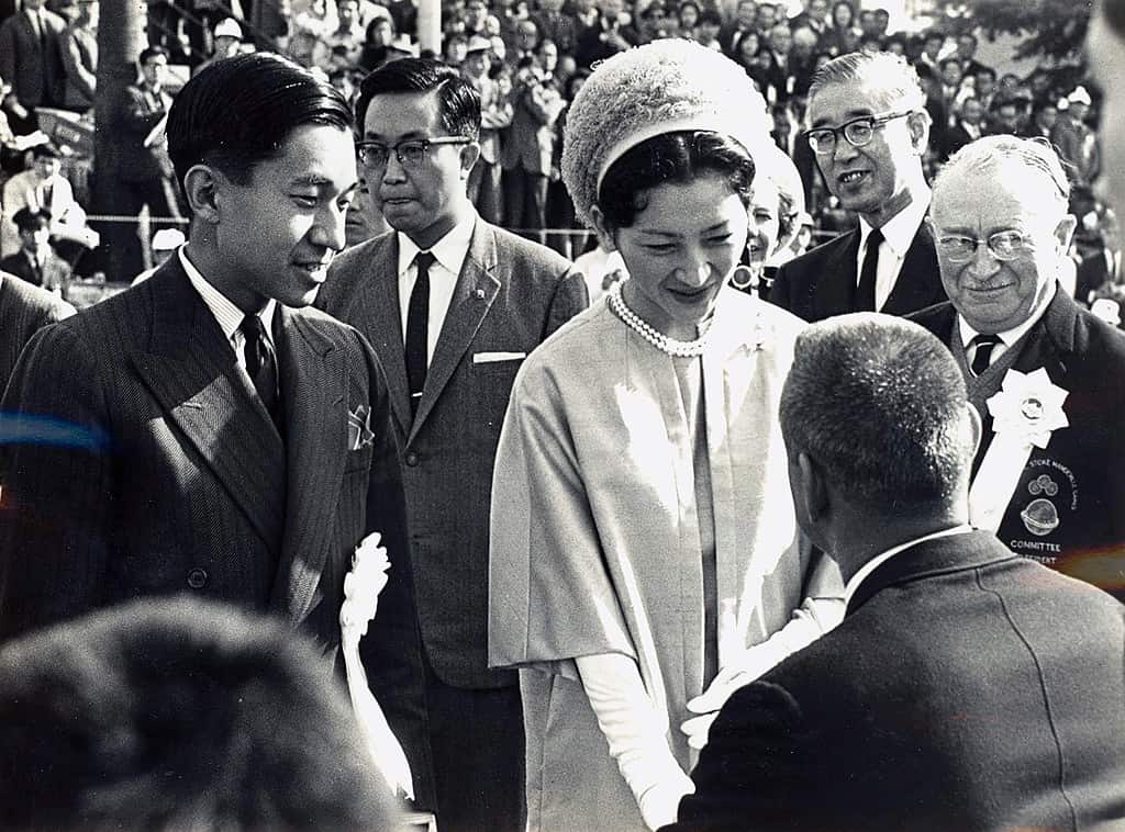Empress Michiko and Crown Prince Akihito (left) meet representatives of the participating teams during the opening ceremony of the 1964 Tokyo Paralympic Games on Oda Field in Yoyogi Park, Tokyo. At the right of the picture is Ludwig Guttmann, the founder of the Paralympic movement.