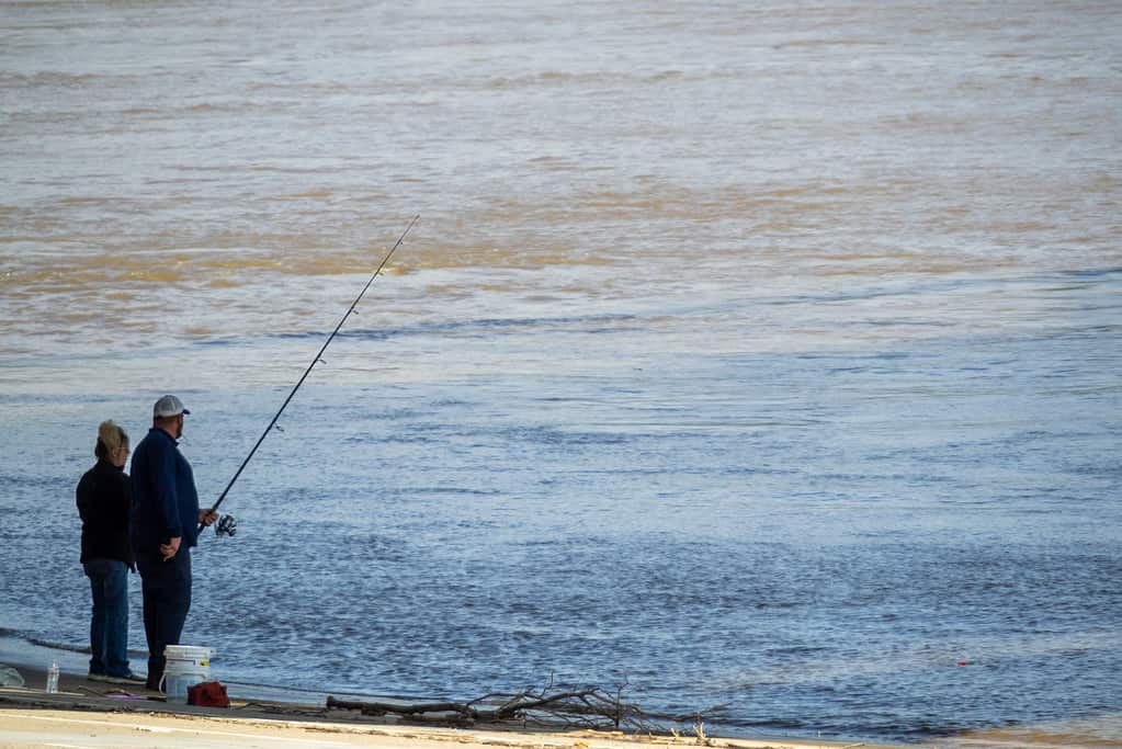 A couple fishes along the banks of the Ohio River in the wake of the Coronavirus COVID-19 pandemic, Wednesday, May 6, 2020, in Cincinnati, Ohio, United States.