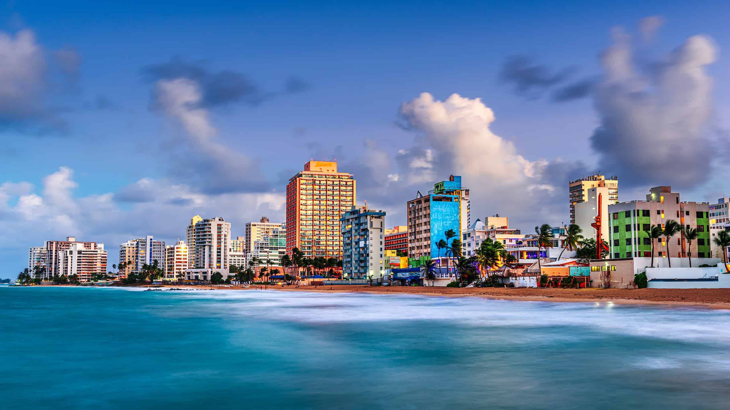 San Juan, Puerto Rico resort skyline on Condado Beach on dusk.