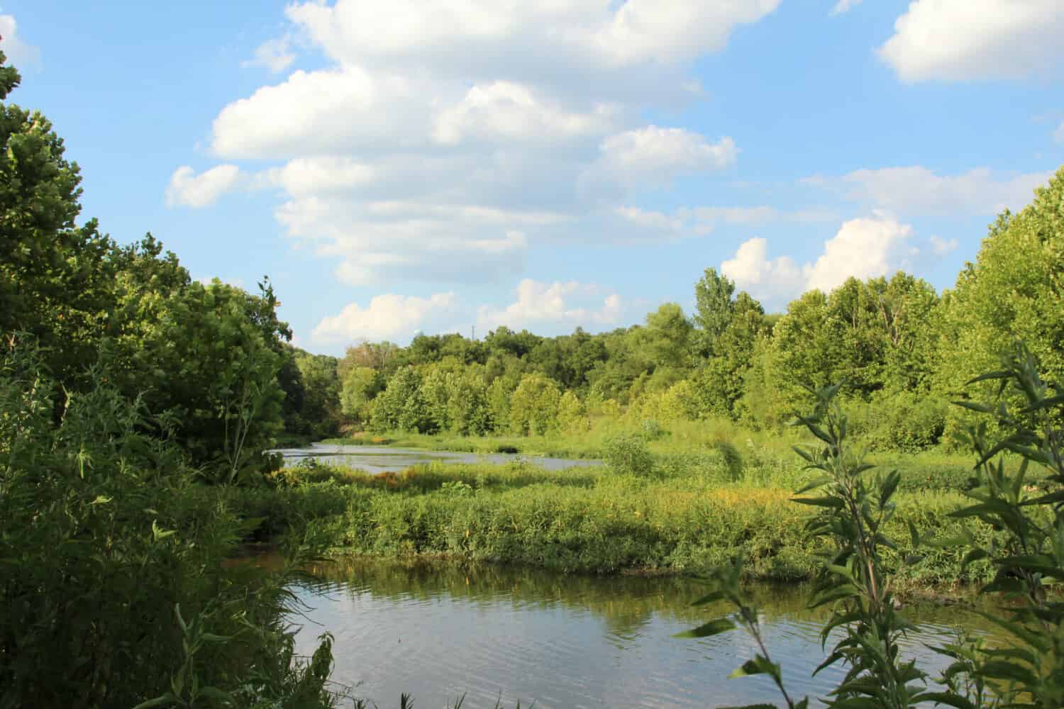 Tranquil summer scene along Sugar Creek at the foothills of the Ozark Mountains in Northwest Arkansas accentuates why Arkansas is known as the natural state.