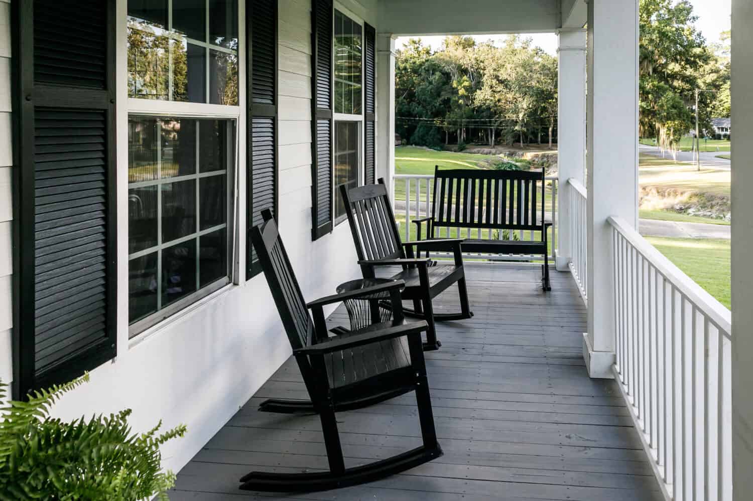 Front Porch of Southern home with Black Rocking Chairs and a Casual Feel
