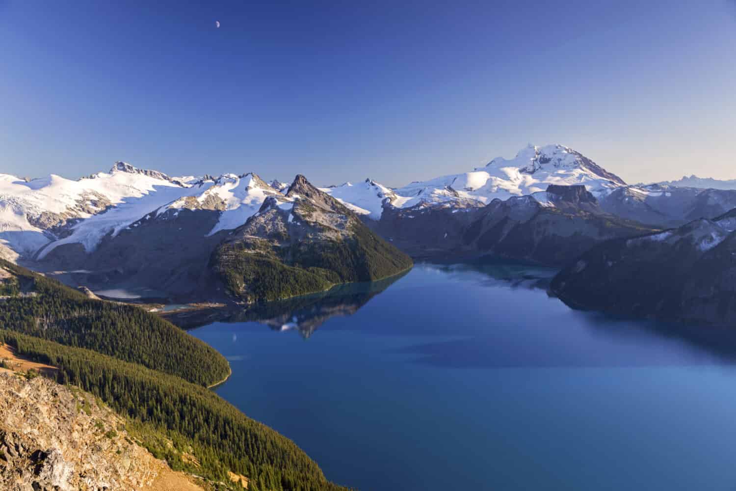 Scenic Landscape View of Blue Garibaldi Lake and Distant Snowcapped Coast Mountains from Panorama Ridge in Sea to Sky Corridor between Squamish and Whistler, British Columbia Canada